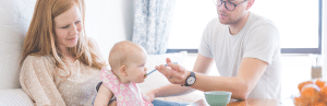 Parents feeding their infant