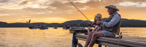 prevent shingles and spend time with family-Grandpa-and-kid-fishing-at-sunset-prevent shingles and spend time with family
