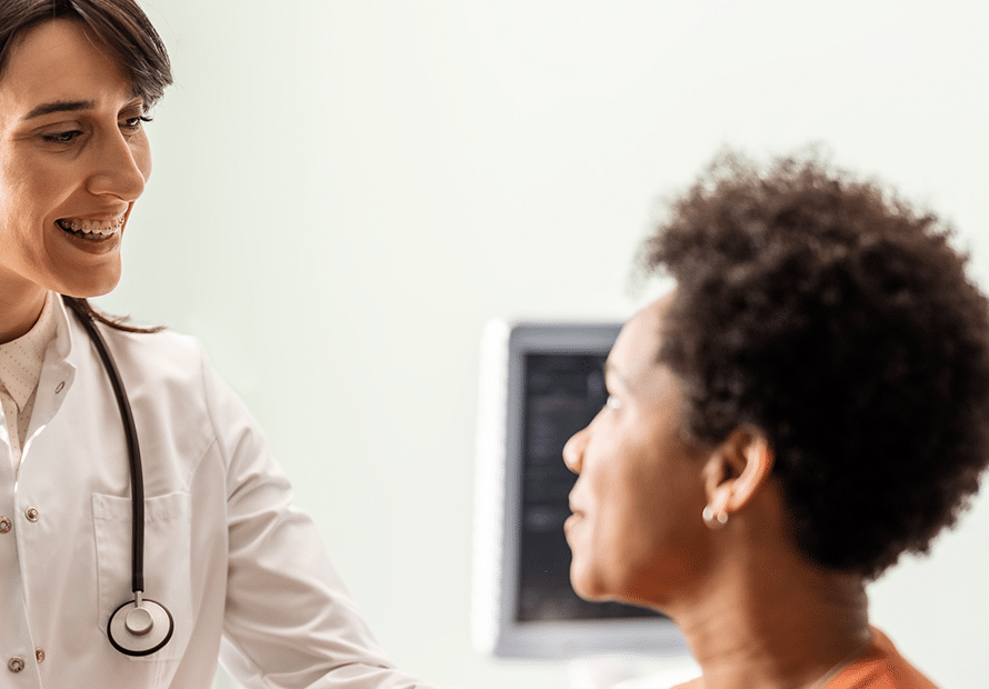 Smiling female clinician gives engaged patient advice