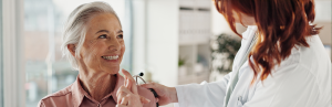Think Earwax is Dirty? Think Again! 2 nurse smiles with senior patient-ear flush