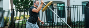 Why Power is More Important Than Strength as We Age 2 Senior man single arm press lunge with barbell